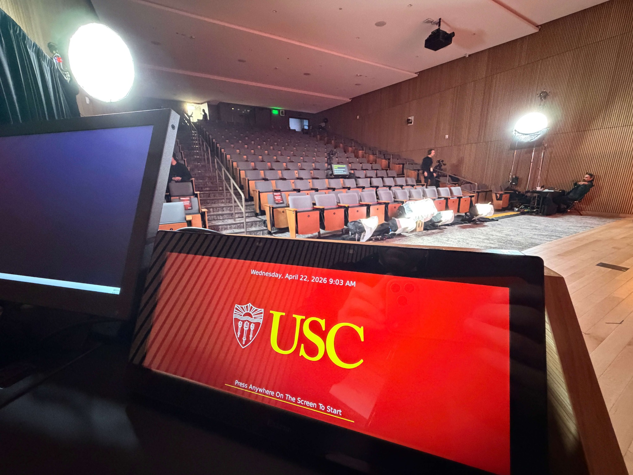 Presenter confidence monitor and stage view inside the USC auditorium during setup